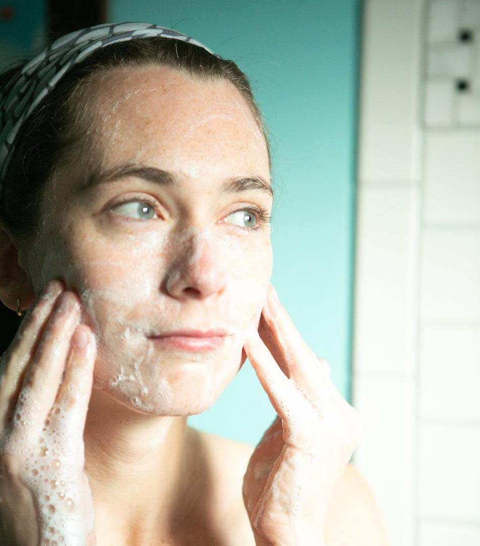 woman cleansing face