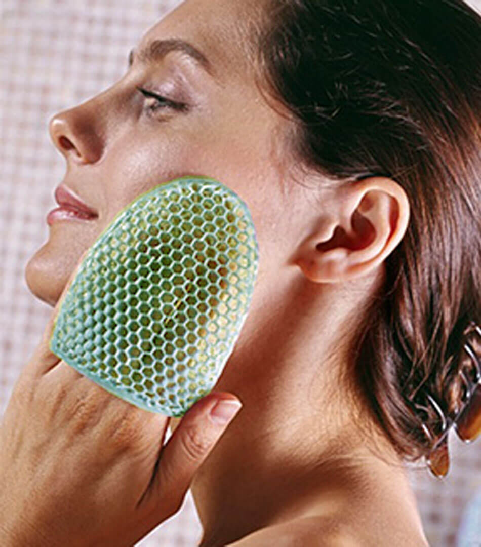 women rubbing with facial sponge