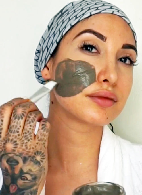 woman applying mud mask