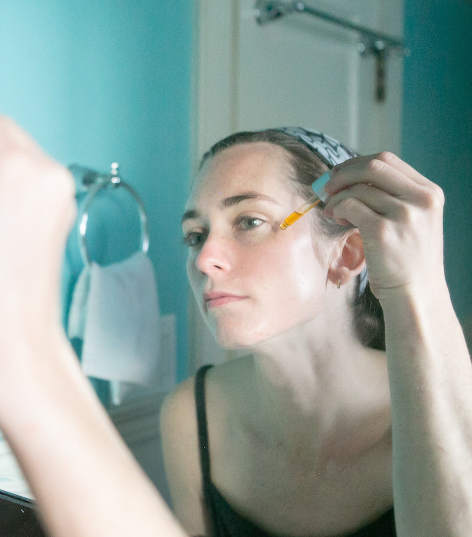 woman applying facial oil for gua sha